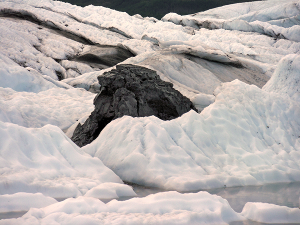 big sheet of ice at Matanuska Glacier and a black stone